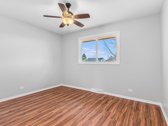 unfurnished room with ceiling fan and hardwood / wood-style flooring