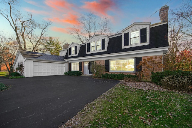 cape cod home featuring a garage