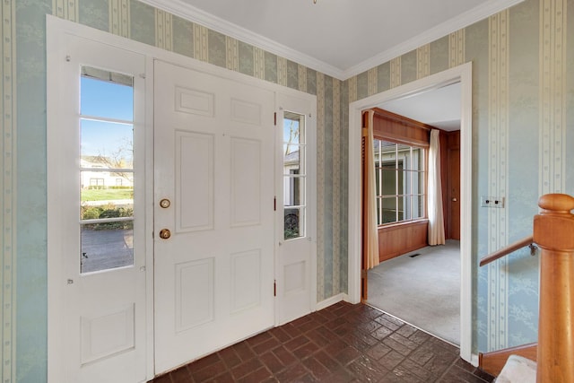 entrance foyer featuring a wealth of natural light and crown molding