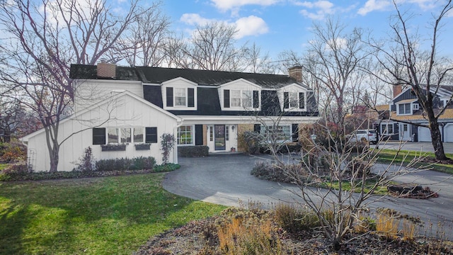 cape cod-style house with a front lawn