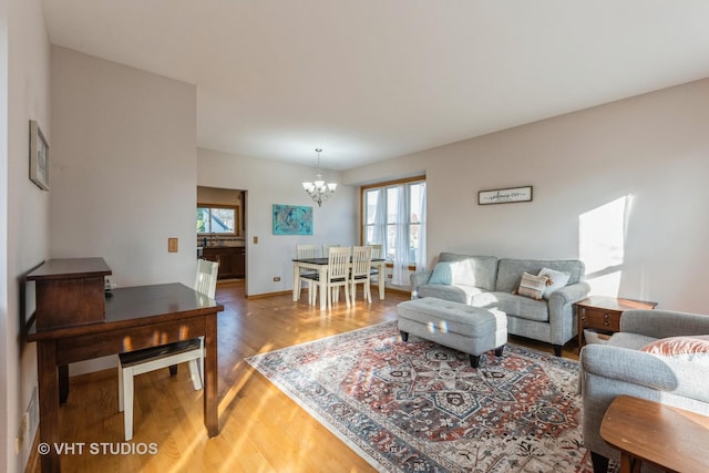 living room featuring hardwood / wood-style floors and a notable chandelier