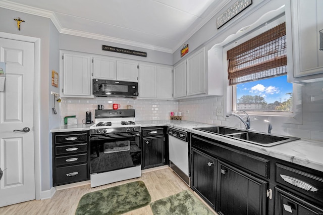 kitchen with light wood-type flooring, dishwashing machine, sink, white range with gas stovetop, and white cabinetry