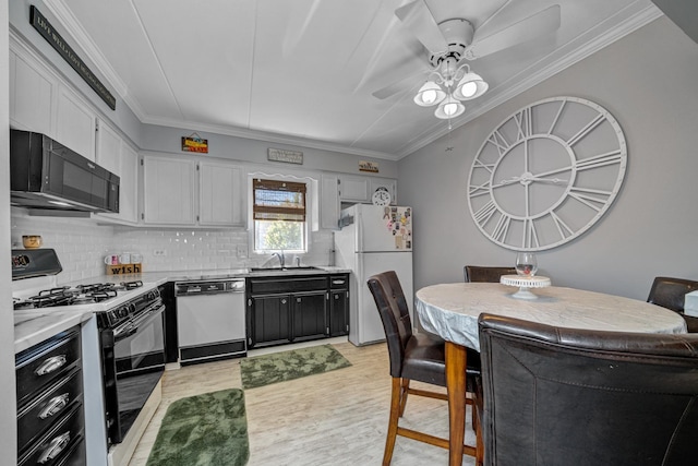 kitchen featuring sink, crown molding, light hardwood / wood-style floors, white appliances, and white cabinets