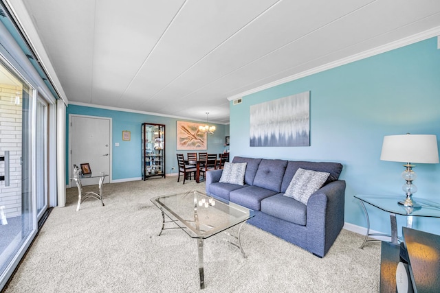 carpeted living room featuring a fireplace, crown molding, and an inviting chandelier