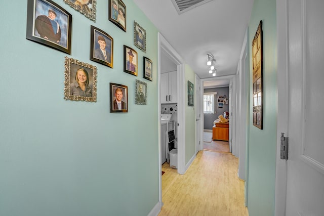 hall with light hardwood / wood-style floors