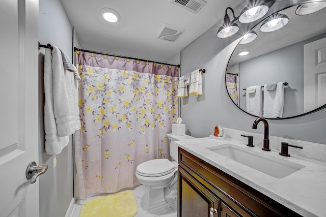 bathroom featuring tile patterned floors, vanity, and toilet