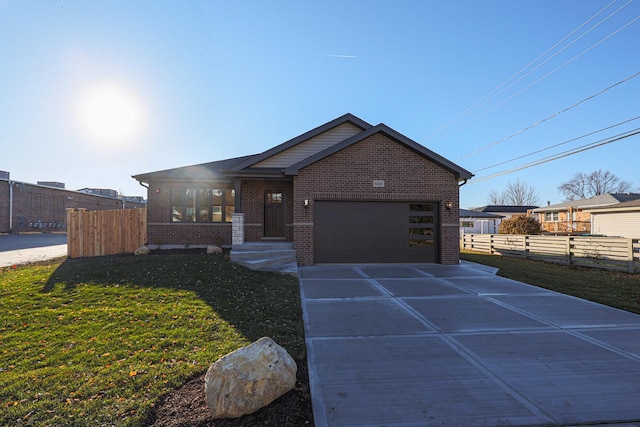 view of front of home with a front yard and a garage