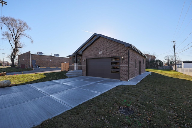 view of side of home featuring a garage and a yard