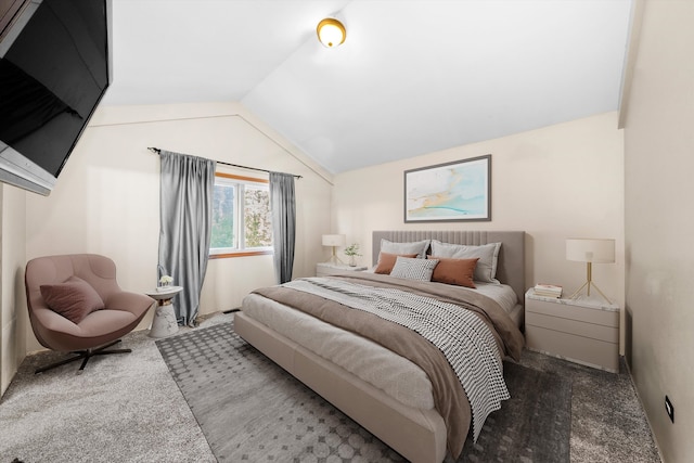 carpeted bedroom with lofted ceiling