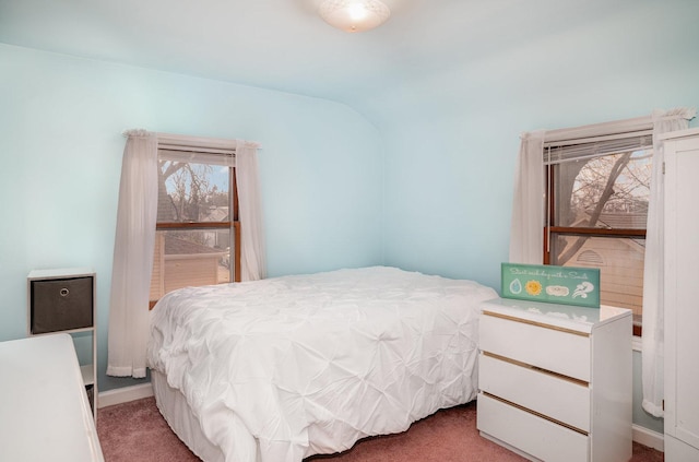 bedroom with multiple windows, carpet, and lofted ceiling