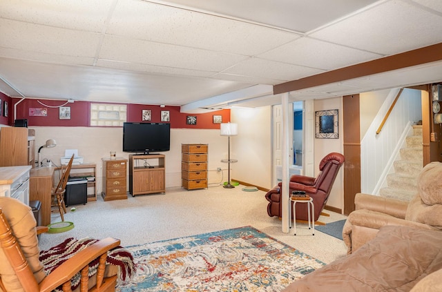 living room featuring carpet and a drop ceiling