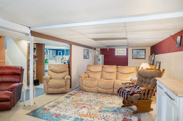 living room featuring a paneled ceiling, light carpet, and water heater