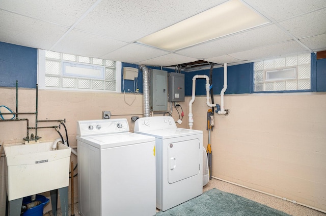 laundry room featuring electric panel, sink, and washer and dryer