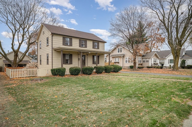 view of front of home with covered porch and a front lawn