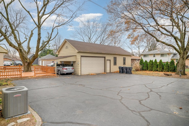 garage featuring central AC unit and a carport