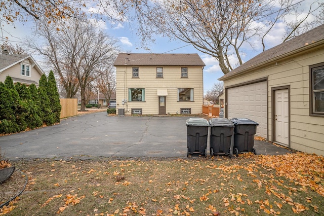 rear view of house with a garage