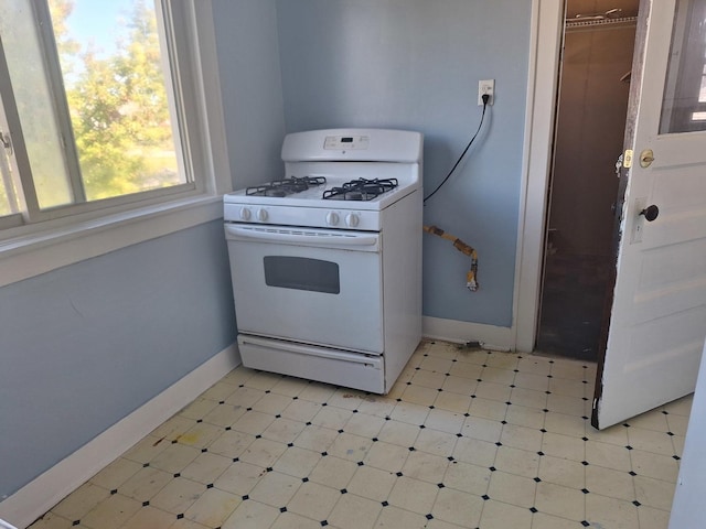 kitchen with white gas range oven