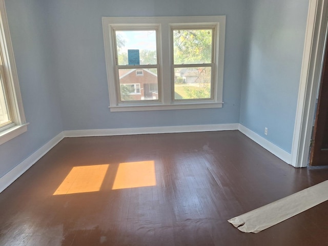 empty room with dark wood-type flooring