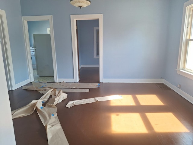 unfurnished room with hardwood / wood-style floors