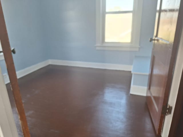 unfurnished room featuring dark hardwood / wood-style floors