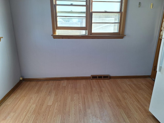 unfurnished room with light wood-type flooring