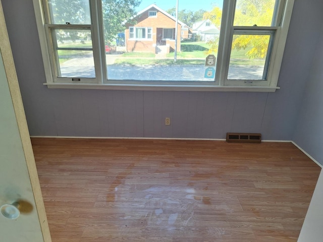 interior space featuring wooden walls and light hardwood / wood-style flooring