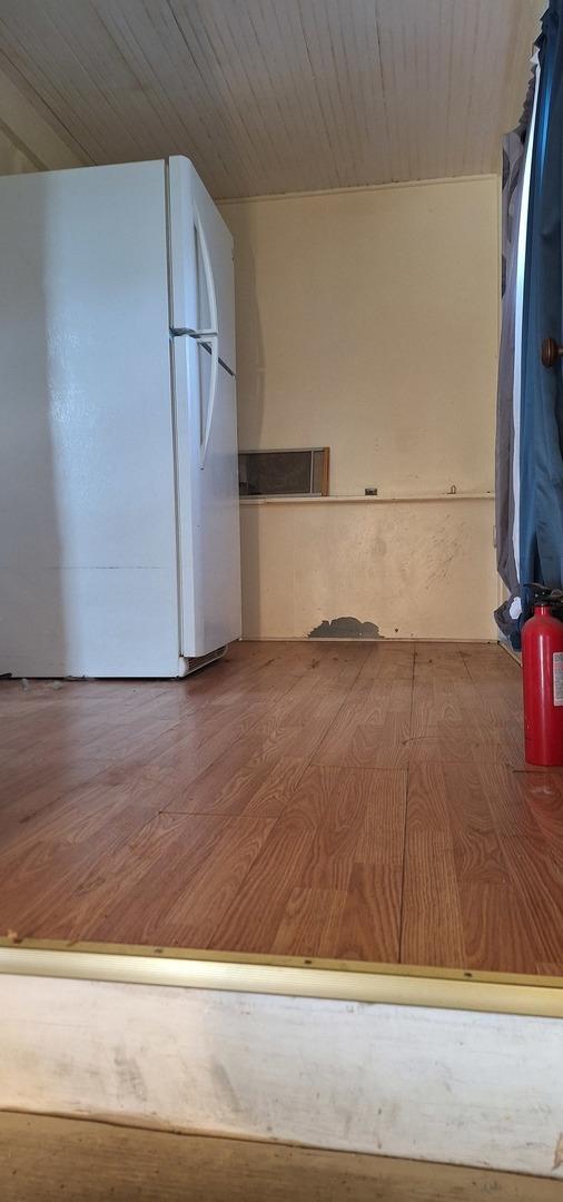 kitchen featuring hardwood / wood-style floors and white fridge