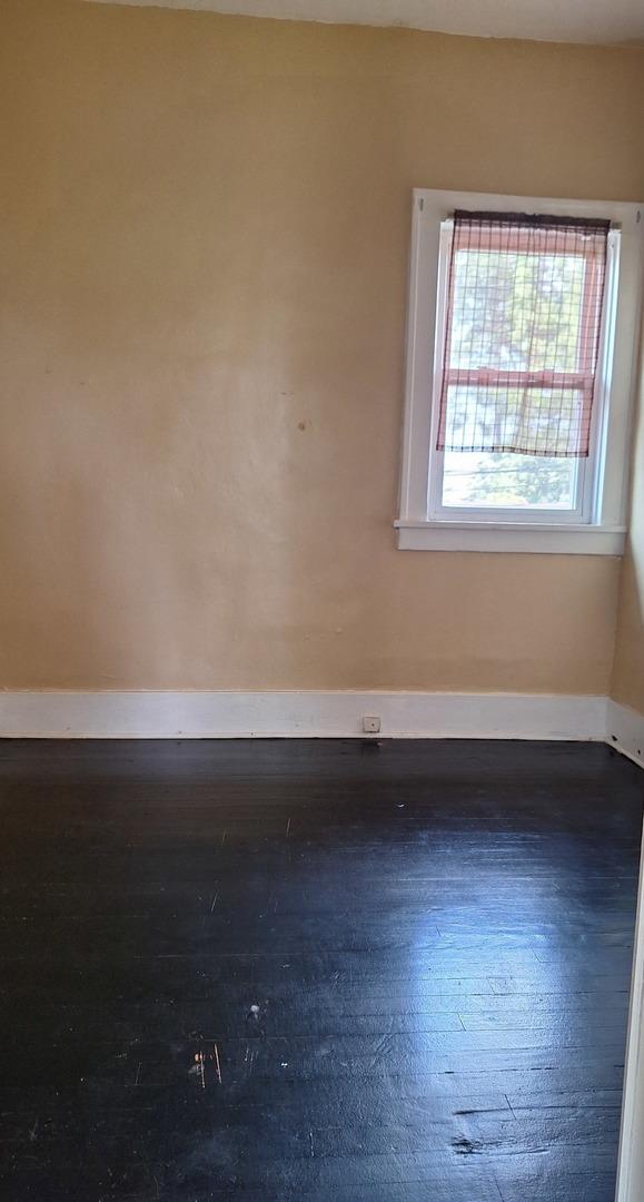 spare room featuring dark hardwood / wood-style floors