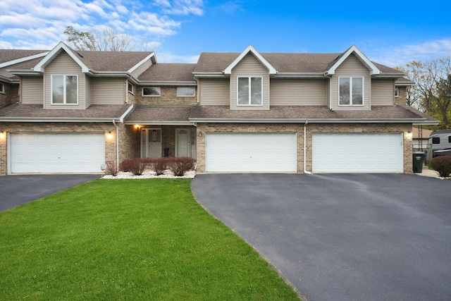 view of front of house featuring a garage and a front lawn