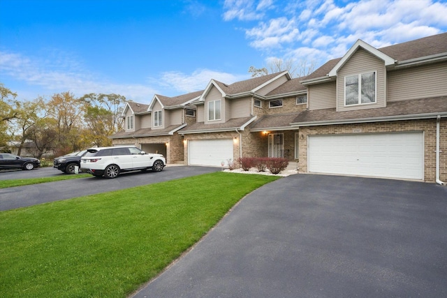 townhome / multi-family property with a garage and a front lawn