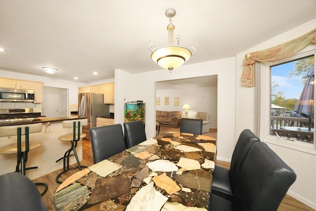 dining space with light hardwood / wood-style flooring