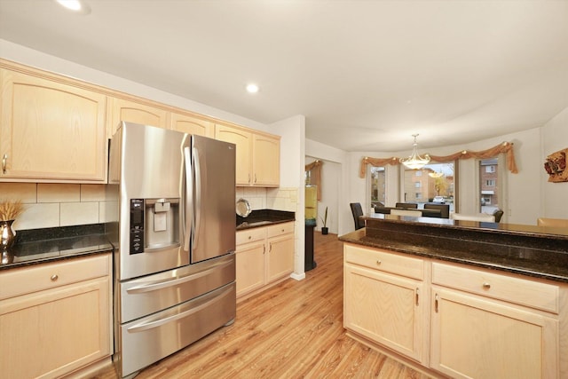 kitchen featuring stainless steel refrigerator with ice dispenser, light brown cabinets, and light hardwood / wood-style flooring