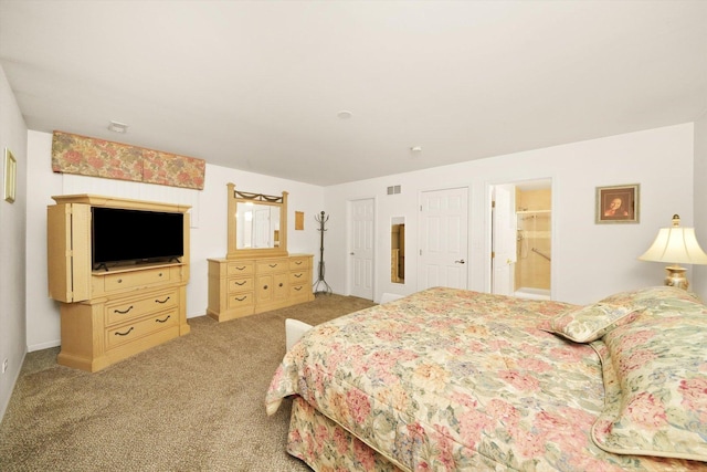 carpeted bedroom featuring connected bathroom