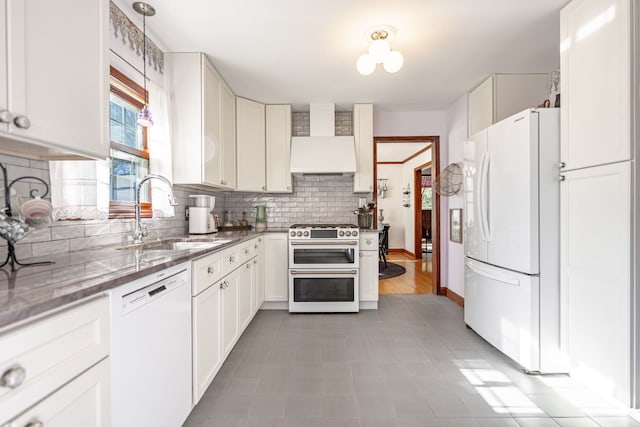 kitchen with white cabinetry, white appliances, wall chimney exhaust hood, and sink