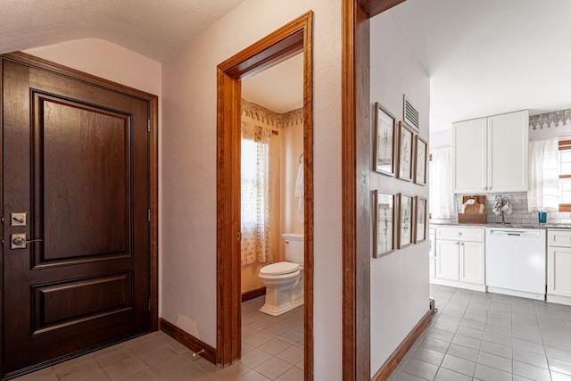 corridor featuring light tile patterned floors