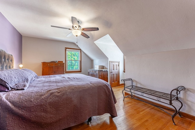 bedroom with vaulted ceiling, ceiling fan, and light wood-type flooring