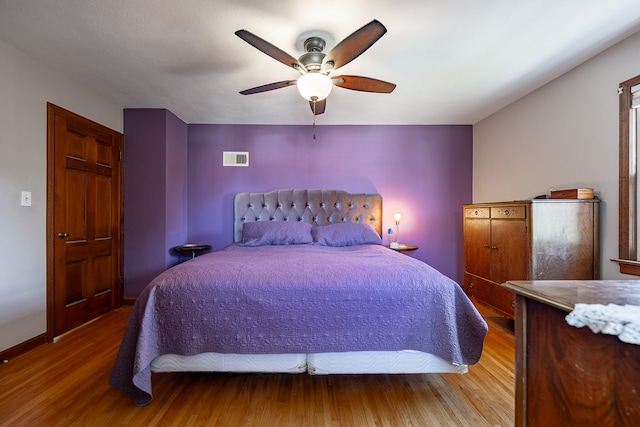 bedroom with hardwood / wood-style flooring and ceiling fan