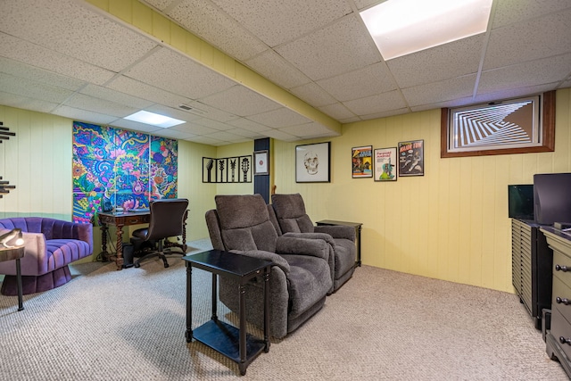 carpeted living room with a drop ceiling