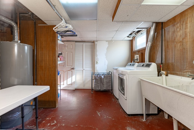 washroom featuring sink, gas water heater, and washer and clothes dryer