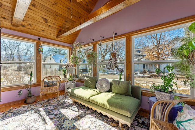 sunroom with lofted ceiling, a wealth of natural light, and wooden ceiling