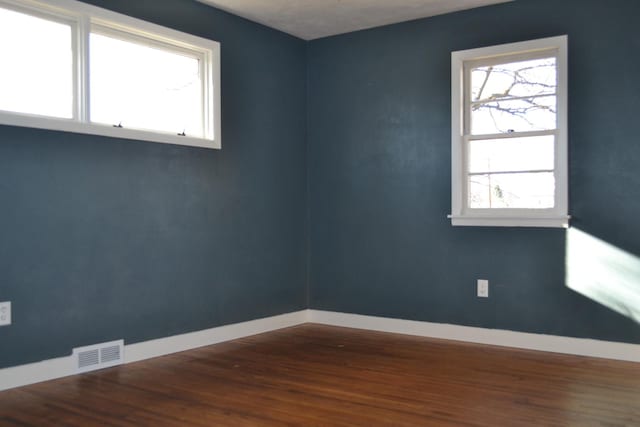 empty room with dark hardwood / wood-style floors