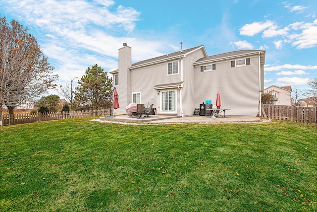 back of property with a lawn and a patio