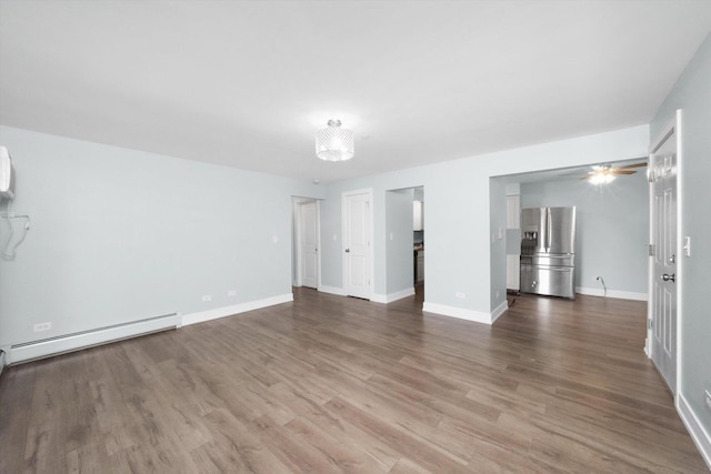 empty room with hardwood / wood-style flooring and baseboard heating