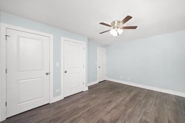 unfurnished bedroom featuring ceiling fan and dark hardwood / wood-style flooring