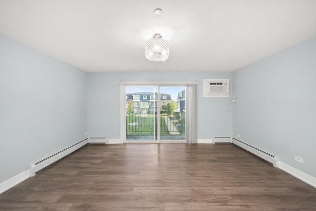 empty room with a notable chandelier, dark hardwood / wood-style flooring, baseboard heating, and a wall unit AC