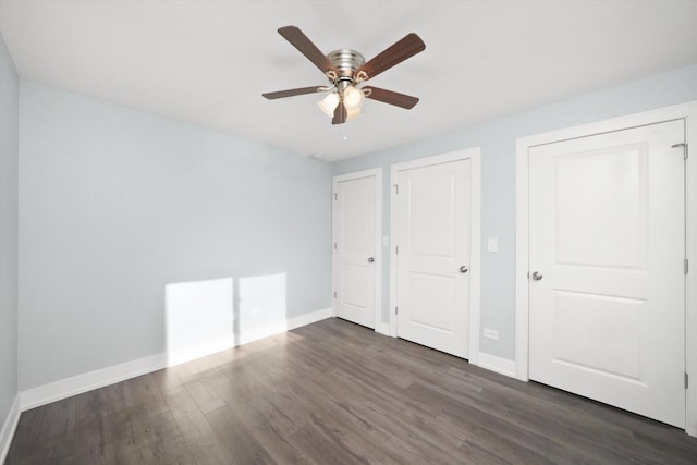 unfurnished bedroom with dark hardwood / wood-style flooring and ceiling fan