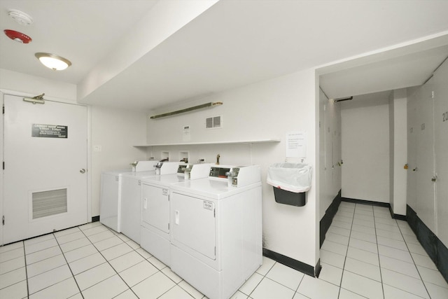 washroom featuring light tile patterned floors and washing machine and clothes dryer