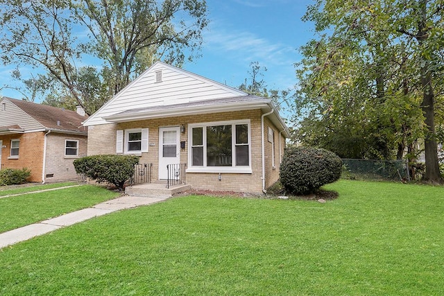 bungalow-style home with a front yard