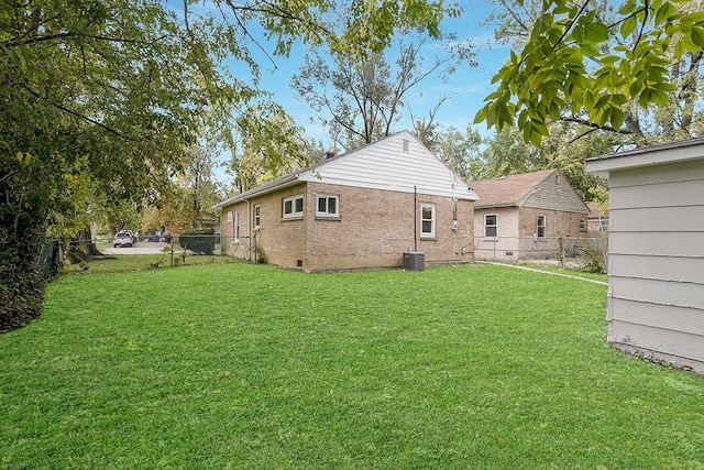 back of house with a lawn