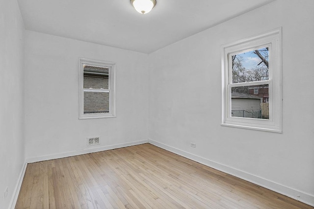 spare room featuring light hardwood / wood-style floors